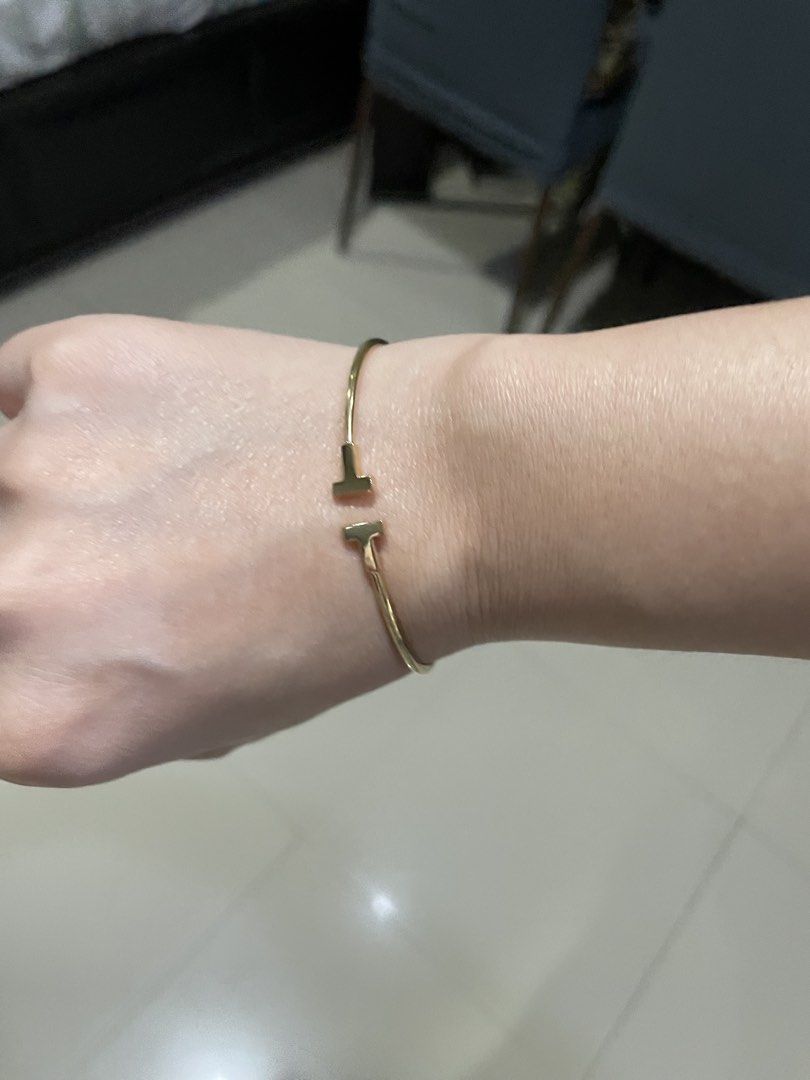 Authentic Tiffany & Co. T Wire Bracelet Gold (Category: Bracelets) located in Quezon City. Submitted by yenggaytot76 (Listing ID 1467099857, Image 3). Description: - Authentic Gold Tiffany & Co. wire bracelet - Iconic T-end design with minimalist open-cuff style - Easy to slip on and off the wrist - Includes original Tiffany turquoise presentation box with black interior lining - Classic and timeless piece perfect for daily wear or gifting.