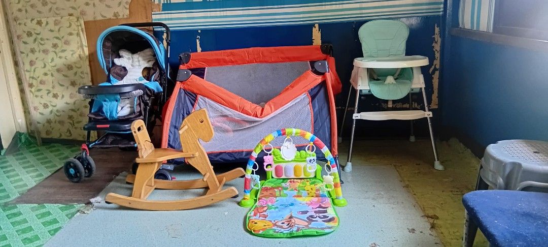 BABY ITEMS TAKE ALL (Category: Infant Playtime) located in Pasig City. Submitted by rhinag (Listing ID 1468886805, Image 2). Description: Bundle includes a blue baby stroller, orange playpen, mint green high chair, wooden rocking horse, and colorful play mat. Everything needed for a nursery or playroom setup. Items show normal wear from use. Sold together as a set. .