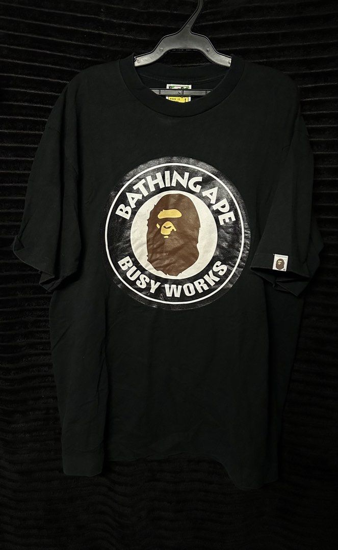 Bape “Busy works” Tee (Category: Tshirts & Polo Shirts ) located in Taguig. Submitted by thriftboy23 (Listing ID 1468753309, Image 1). Description: BAPE TEE “BUSY WORKS” Excellent Condition Issue: Minimal hairlines No major flaws Color rate: 9.5/10 Width: 21 Length: 27.5 Location: Pinagsama Taguig.