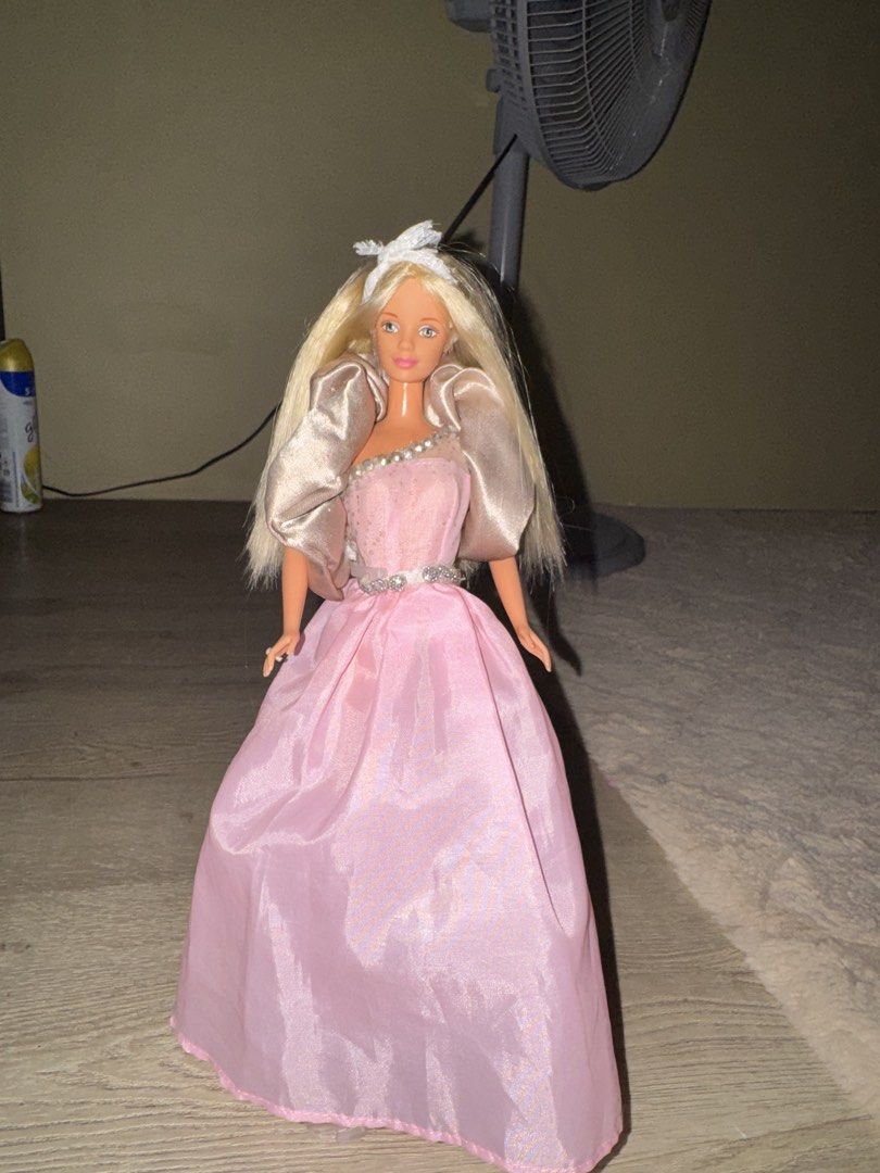 barbie doll (Category: Kids Toys) located in Castillejos. Submitted by yuuukiyu (Listing ID 1468775804, Image 1). Description: MOD-JNT MOP- GCASH UNIDENTIFIED BARBIE FOR SALE! -DRESS COMES FROM FASHION PACK -STAIN ON ONE FOOT -ADDED GEMS ON THE DRESS -NO CRACK NECK - HAIR HAS BEEN WASHED.