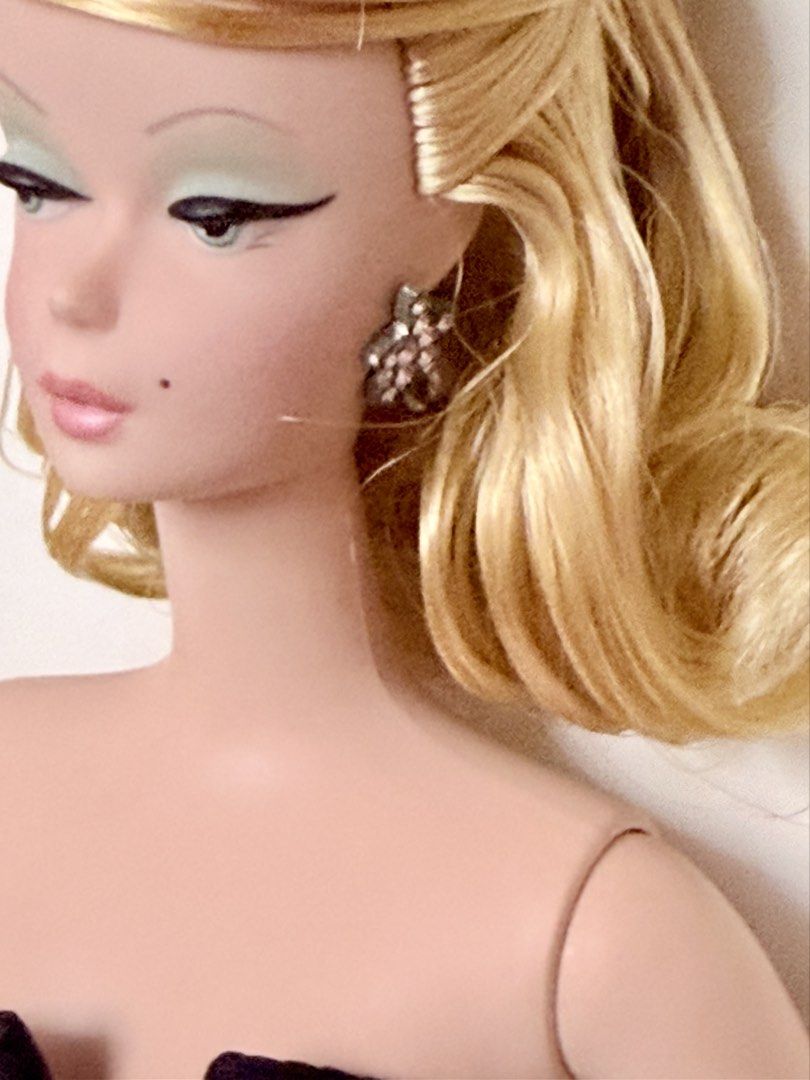 Barbie Silkstone Doll bundle (Category: Figurines & Statues) located in Manila. Submitted by lovelovedlove (Listing ID 1468928996, Image 3). Description: - Lisette is almost new, complete with certificate - Delphine is nude, hair in original style, never washed.- Stunning blonde Barbie doll in a formal green satin and black strapless gown - Detailed facial makeup with dramatic winged eyeliner, pastel eyeshadow, and beauty mark - Comes with sparkl