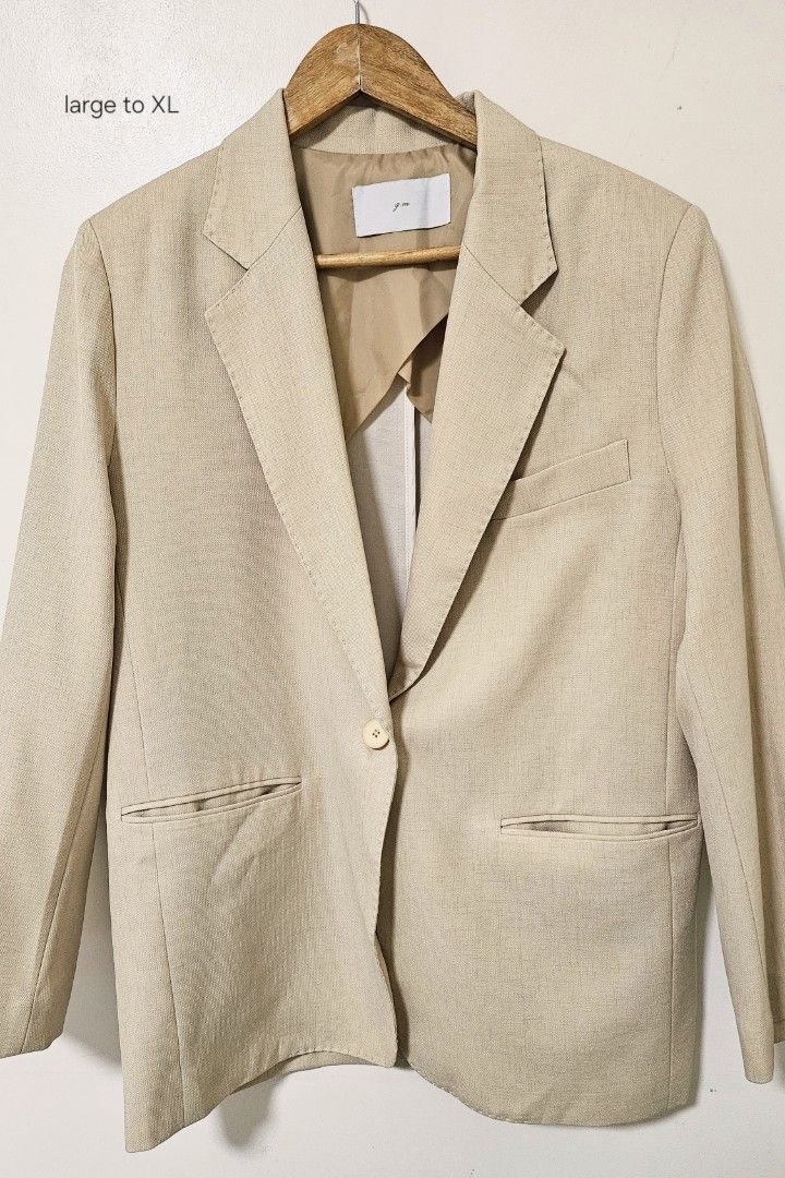 Beige oversized blazer jacket size large to XL (Category: Coats, Jackets and Outerwear) located in Laoag. Submitted by __baptistakim (Listing ID 1468831433, Image 1). Description: Beige blazer, linen-like fabric texture. Single button closure in the front, light-colored button. Two front pockets with flaps. One chest pocket on the left side. Structured shoulders with standard lapels. Partially lined interior in beige. Fits large to XL. Great neut