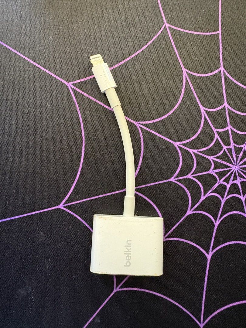 Belkin Lightning Audio + Charge Adapter (Category: Chargers & Cables) located in Caloocan City. Submitted by gabrielcorpuz_07 (Listing ID 1468712795, Image 3). Description: - Brand: Belkin - Color: White - Ports: 1x Lightning charging port, 1x 3.5mm headphone jack - Function: Charge your iPhone and listen to music simultaneously - Condition: Minor signs of wear on the plastic housing, fully working - Compatibility: Works with Lightning-equipped i