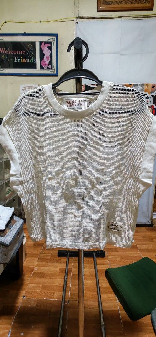Bench x Willy Chavarria White Mesh Top (Category: Coats, Jackets and Outerwear) located in Manila. Submitted by declutter_bae (Listing ID 1468905834, Image 2). Description: - Official Bench x Willy Chavarria collaboration - Color: White - Fit: Loose, boxy fit with short sleeves - Fabric: Lightweight open weave mesh (slightly sheer) - Details: Ribbed collar and cuffs, woven patch label on bottom left hem - Style: Great streetwear piece, ideal for 