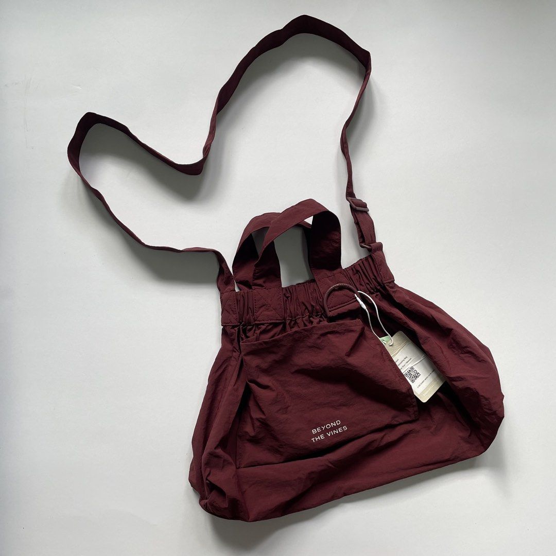 Beyond The Vines M Dumpling Bag Maroon (Category: Shoulder Bags) located in Pasay City. Submitted by lovedbyzea (Listing ID 1468785680, Image 1). Description: - Brand: Beyond The Vines - Style: M Dumpling Bag - Color: Maroon - Condition: Brand new with tags (BNWT) - Size: Medium, perfect everyday carryall - Material: Lightweight and durable nylon - Features: Packs into its own front pocket, adjustable crossbody strap, top handle grab loops, secur