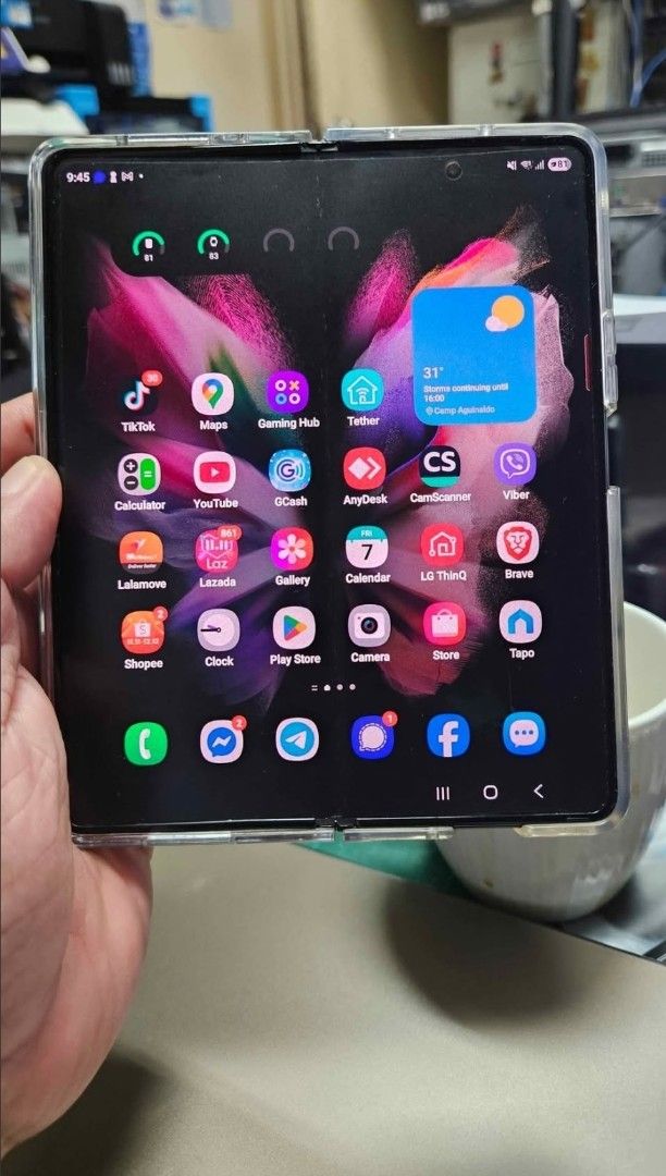 Samsung Galaxy Fold 3 (Category: Samsung) located in Mandaluyong City. Submitted by theosystem (Listing ID 1468779766, Image 2). Description: - Model: Samsung Galaxy Z Fold 3 - Storage: 256GB - Memory: 12GB - Condition: Good working condition with clean displays - Features: Large foldable main screen and convenient cover screen - Inclusion: 4 Cases Status: Unlocked SIM1 and SIM2. can add 5 eSIMs. both main and front screen are working - no lines 