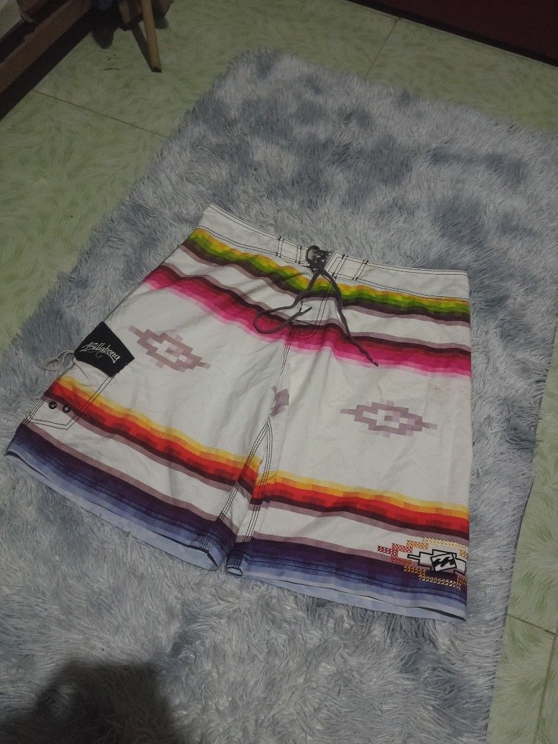 Billabong Board Shorts Aztec Print Size 38 (Category: Swim Trunks & Board Shorts) located in Lingayen. Submitted by rahzzelula73279 (Listing ID 1468727898, Image 1). Description: - Brand: Billabong - Size: 38 - Material: 100% Polyester (Made in China) - Design: White base with vibrant horizontal stripes and Aztec diamond graphics - Closure: Adjustable drawstring waist - Pockets: Velcro side pocket with signature embroidered logo tag - Care: Cold 