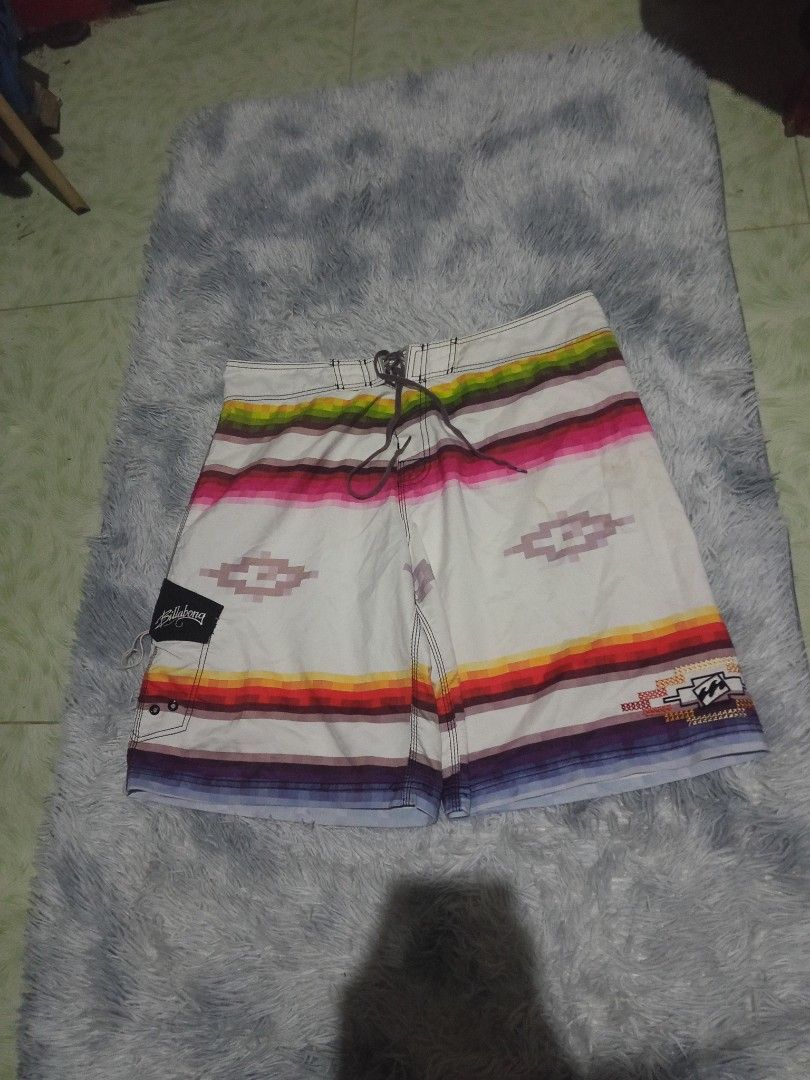Billabong Board Shorts Aztec Print Size 38 (Category: Swim Trunks & Board Shorts) located in Lingayen. Submitted by rahzzelula73279 (Listing ID 1468727898, Image 3). Description: - Brand: Billabong - Size: 38 - Material: 100% Polyester (Made in China) - Design: White base with vibrant horizontal stripes and Aztec diamond graphics - Closure: Adjustable drawstring waist - Pockets: Velcro side pocket with signature embroidered logo tag - Care: Cold 