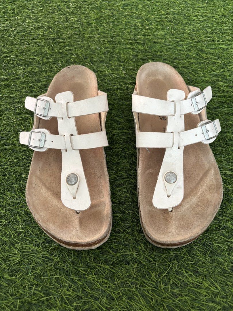 Birkenstock White T-Strap Sandals Size 40 (Category: Flats & Sandals) located in Makati City. Submitted by rare_thrift_stuff (Listing ID 1468730916, Image 2). Description: - Brand: Birkenstock - Color: White - Size: EU 40 - Style: T-strap with double adjustable buckle straps - Material/Features: Cork footbed, patterned rubber outsole, Made in Germany - Condition: Normal wear on footbeds and outsoles from previous use - 100% authentic and super co