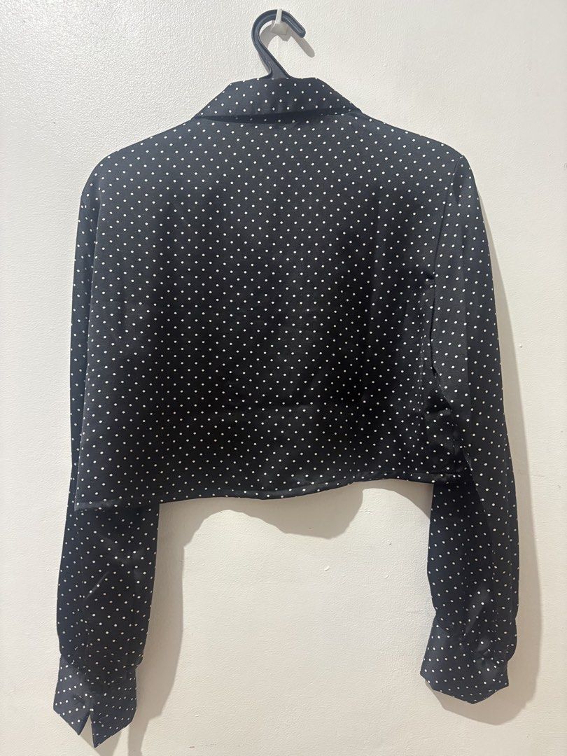 Black and White Polka Dot Crop Blouse (Category: Blouses) located in Manila. Submitted by nykji96 (Listing ID 1468715016, Image 2). Description: - Color/Pattern: Black with all-over white polka dots - Style: Cropped long sleeve blouse with collar neckline - Details: Front button closure and wide buttoned cuffs - Material: Lightweight satin-like fabric.