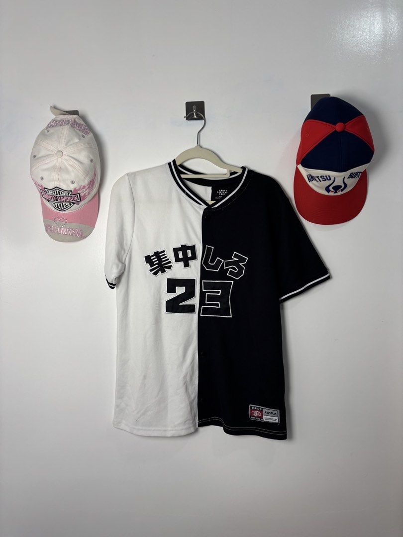 Black and White Split Baseball Jersey Number 23 (Category: Activewear) located in Calbayog City. Submitted by zaxcheus_castillo1708 (Listing ID 1468754402, Image 1). Description: - Style: Half black/half white button-down jersey streetwear piece - Details: Japanese characters and large number 23 printed across the chest - Accents: Striped ribbing on collar and short sleeves, plus a small woven tag near the bottom hem - Condition: Clean fabric, ze