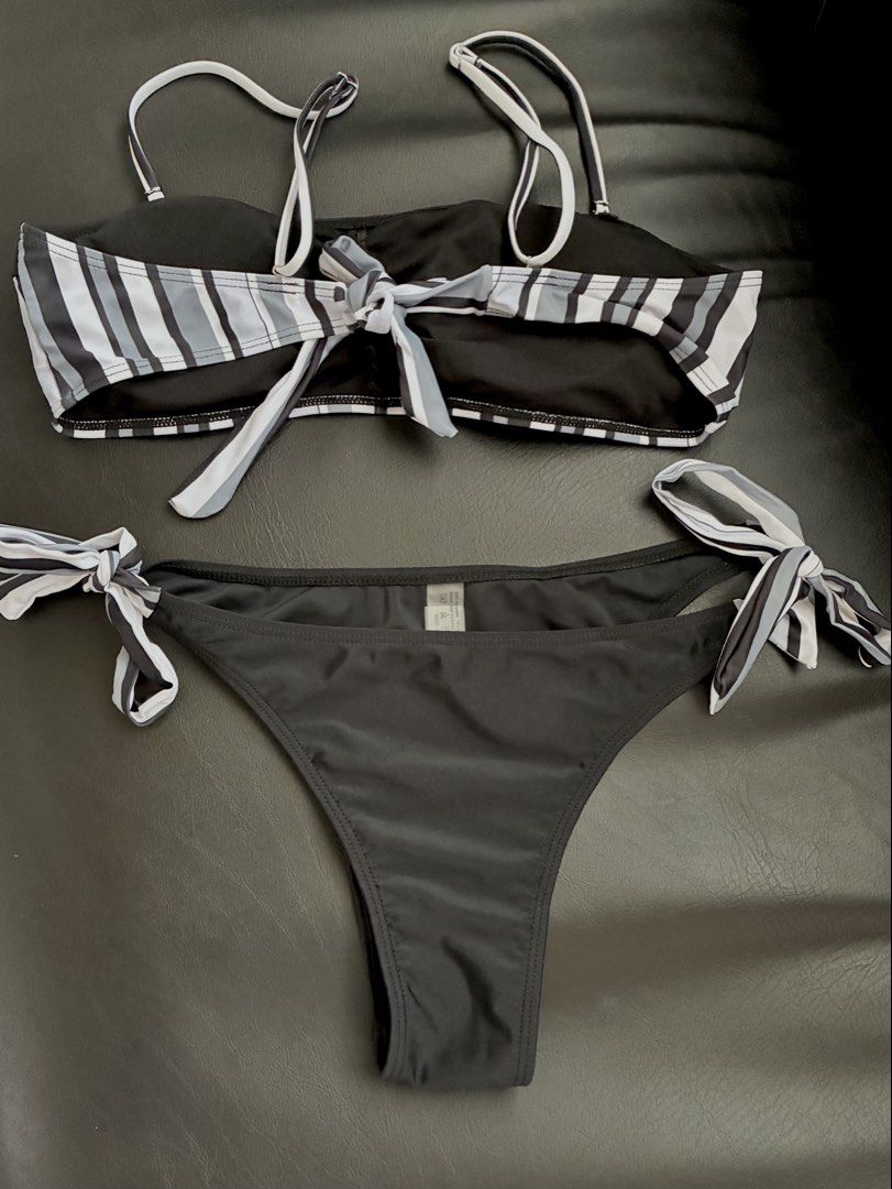 Black and White Striped Bikini Set with Adjustable Straps (Category: Bikinis & Swimsuits) located in Tanauan. Submitted by theitgirlsdibs4 (Listing ID 1468738244, Image 2). Description: - Classic black and white striped bandeau top - Thin adjustable shoulder straps and tie-back closure - Matching solid black bottoms with adjustable side ties - Clean, brand-new fabric with original tag attached inside bottoms - Ideal for the beach, pool, or tropic