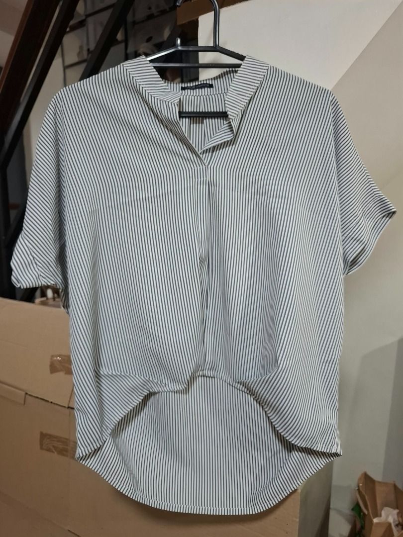 Black and White Striped Blouse (Category: Blouses) located in Pasig City. Submitted by dripcounty (Listing ID 1468836106, Image 1). Description: Black and White Striped Blouse ₱150 Size: Unconfirmed — please confirm in chat Condition: Preloved; please check actual photos Vertical stripe blouse with split neckline, short sleeves and high-low hem. Actual item shown in photos. Delivery fee shouldered by buyer (Lalamove / other courier). Item price e
