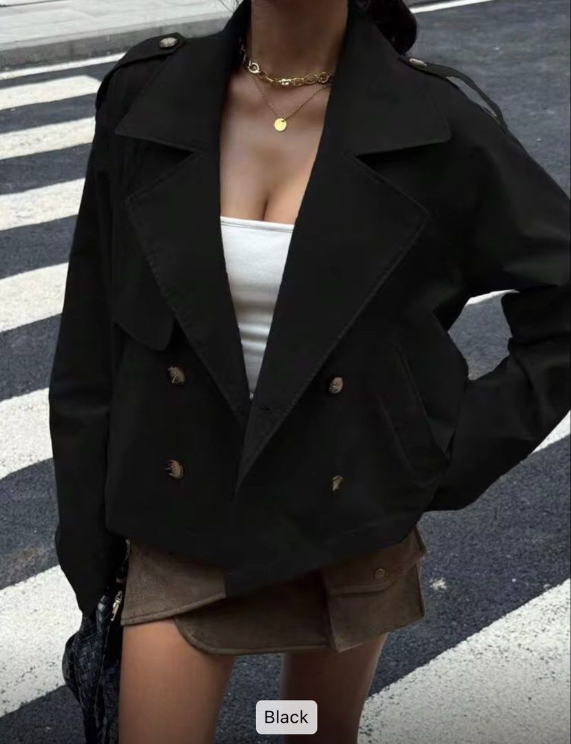 Black Double Breasted Cropped Trench Jacket (Category: Coats, Jackets and Outerwear) located in Villasis. Submitted by juliaxgamboa (Listing ID 1468808696, Image 3). Description: - Color: Clean solid black - Design: Double-breasted with tortoise-shell buttons - Features: Wide lapel collar and shoulder epaulets - Fit: Structured cropped length, ideal for layering - Material: Smooth, high-quality fabric construction.