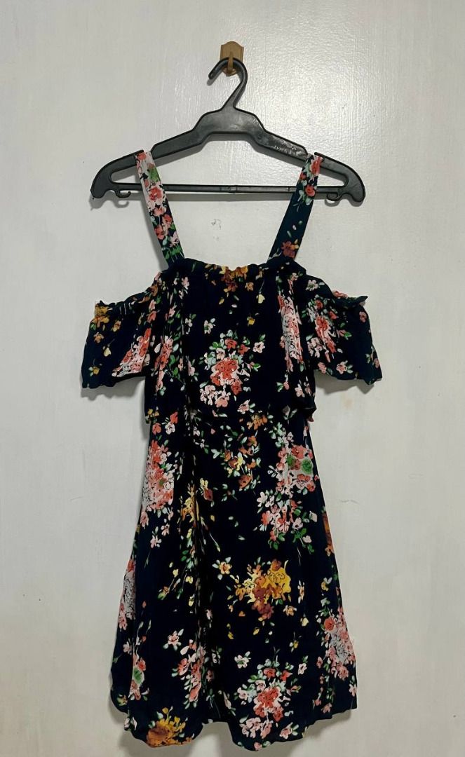 Black Floral Off-Shoulder Dress (Category: Dresses) located in Paranaque City. Submitted by littledairyqueen (Listing ID 1468871625, Image 1). Description: Black Floral Off-Shoulder Dress 🌸🌷 A feminine floral dress featuring a beautiful black base with pink, peach, yellow, and white flower prints! Designed with an off-shoulder neckline and shoulder straps, perfect for casual outings, brunch dates, vacations, or a cute and effortless summer look