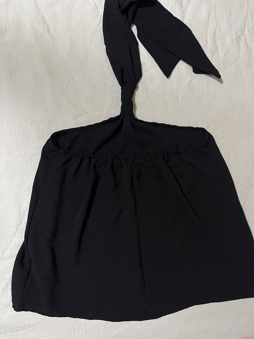 Black Halter Top with Tie Neck (Category: Sleeveless) located in Quezon City. Submitted by earthtodior (Listing ID 1468733504, Image 1). Description: - Color: Solid black - Style: Halter neck top with self-tie straps - Details: Chic gathering along the neckline - Fabric: Light and flowy drape - Versatility: Great for casual days or nights out; pairs easily with high-waisted jeans or skirts - Condition: Clean and well-maintained.