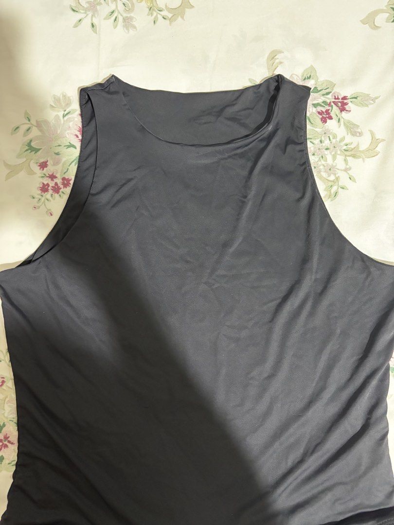 Black high neck sleeveless bodysuit (Category: Sleeveless) located in Pasig City. Submitted by closetcleanoutmnl (Listing ID 1468779074, Image 3). Description: - Color: Solid Black - Style: Sleeveless with a trendy high neckline - Fit: Stretchy, smooth, and body-hugging - Closure: Bottom snap buttons for easy wear - Versatility: Perfect for pairing with denim, shorts, or skirts.