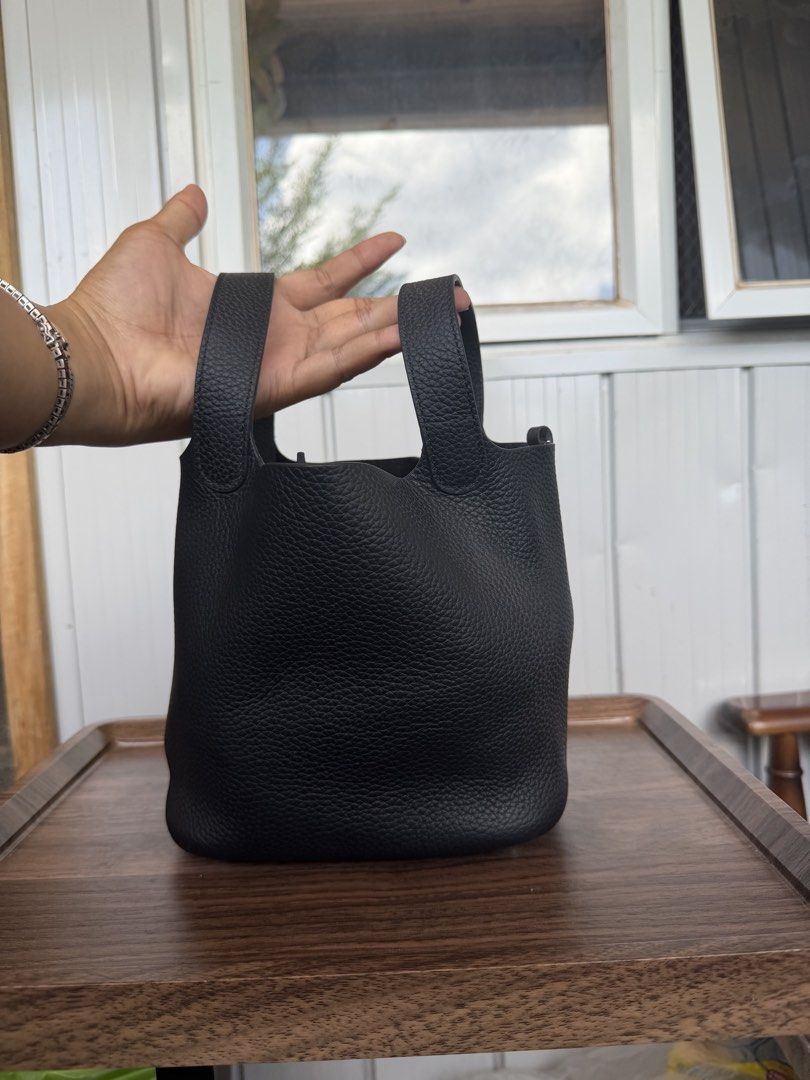 Black Leather Bucket Bag with Top Handles (Category: Shoulder Bags) located in Digos. Submitted by old_soul. (Listing ID 1468724938, Image 1). Description: - Material: Premium black pebbled leather - Design: Structured bucket bag with a minimalist everyday style - Handles: Convenient dual top handles for easy carrying - Protection: Metal feet on the bottom base to prevent wear and tear - Interior: Clean and spacious enough for your daily essentia