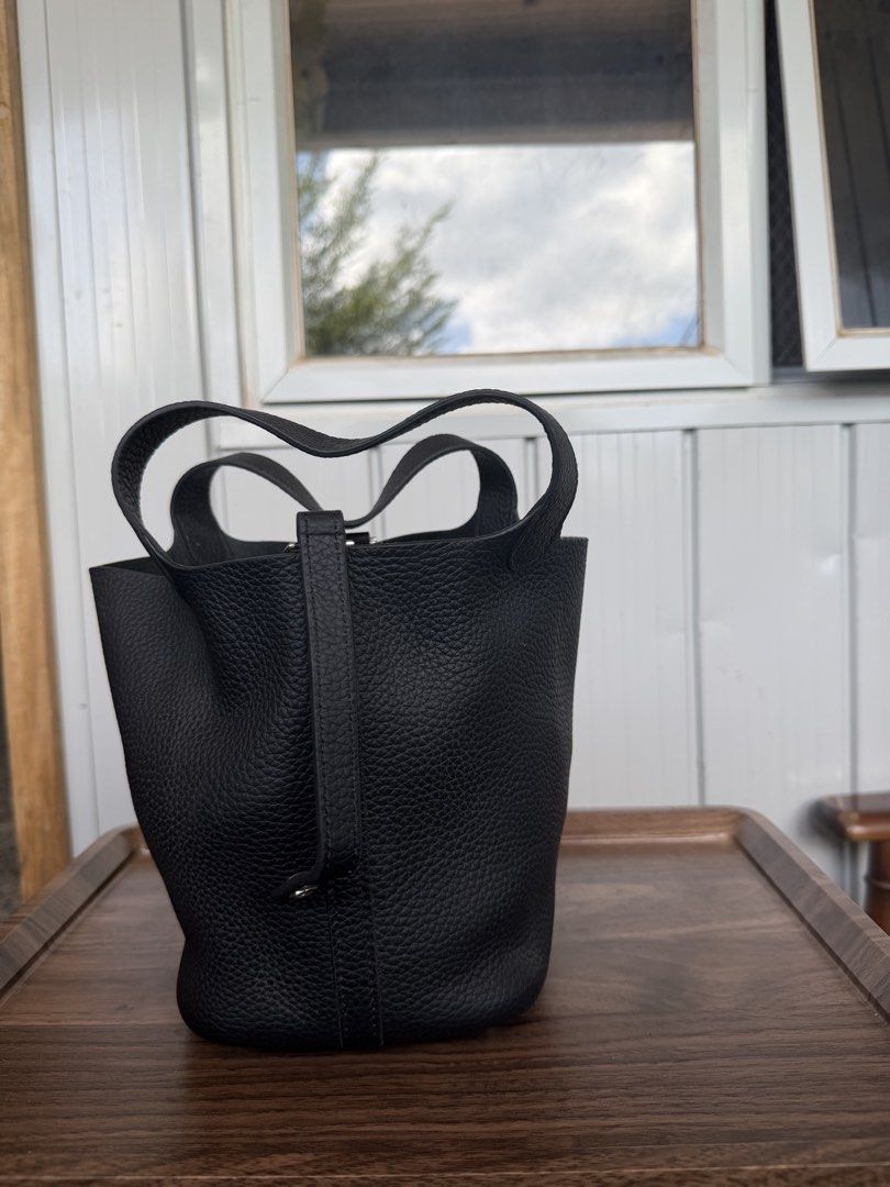 Black Leather Bucket Bag with Top Handles (Category: Shoulder Bags) located in Digos. Submitted by old_soul. (Listing ID 1468724938, Image 2). Description: - Material: Premium black pebbled leather - Design: Structured bucket bag with a minimalist everyday style - Handles: Convenient dual top handles for easy carrying - Protection: Metal feet on the bottom base to prevent wear and tear - Interior: Clean and spacious enough for your daily essentia