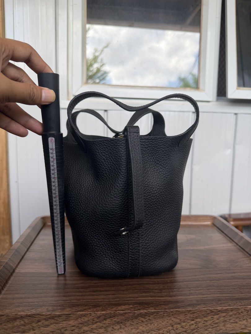 Black Leather Bucket Bag with Top Handles (Category: Shoulder Bags) located in Digos. Submitted by old_soul. (Listing ID 1468724938, Image 3). Description: - Material: Premium black pebbled leather - Design: Structured bucket bag with a minimalist everyday style - Handles: Convenient dual top handles for easy carrying - Protection: Metal feet on the bottom base to prevent wear and tear - Interior: Clean and spacious enough for your daily essentia