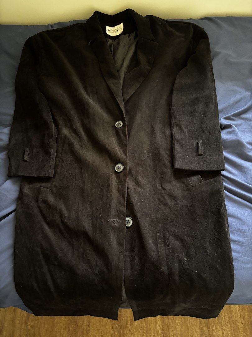 Black Long Trench Coat Overcoat (Category: Coats, Jackets and Outerwear) located in Manila. Submitted by prelovedbykleng (Listing ID 1468850175, Image 1). Description: Fits M-L - Brand: Americano - Style: Long black coat with classic lapel collar - Closure: Front button closure - Features: Side pockets, button strap details on cuffs, fully lined interior - Condition: Excellent - Perfect for: Cold weather layering and dark, sleek outfits.