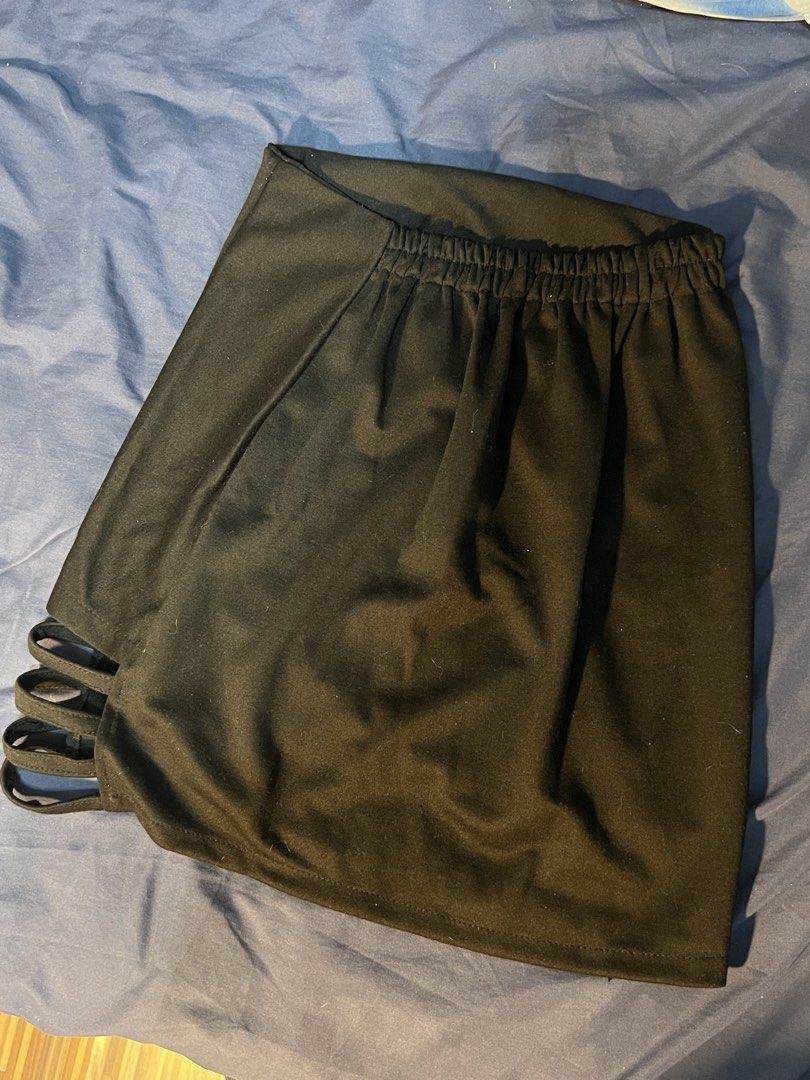 Black mini skirt with side cutout strap details (Category: Skirts) located in Marikina City. Submitted by yssacee (Listing ID 1468916401, Image 3). Description: - Color: Solid black - Fit: Stretchy fabric with an elastic waistband in the back for easy wear - Design: Pull-on style with trendy cutout strap details on the side hem - Length: Mini skirt - PM for more photos, sizing inquiry - fits XS-S womens - shipping from lower Antipolo Rizal.