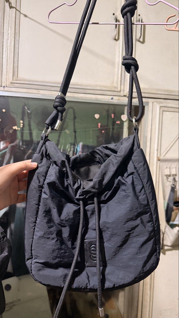 Black Nylon Puffer Shoulder Bag & Drawstring Bucket Bag Set (Category: Shoulder Bags) located in Cainta. Submitted by frtzjy_ (Listing ID 1468763924, Image 3). Description: - Set of 2 versatile black bags made from lightweight crinkled nylon - Bag 1: Structured flap design with quilted sections and a front logo patch - Bag 2: Slouchy drawstring bucket bag with thick rope straps - Adjustable knots on cords allow easy drop length customization - Pe