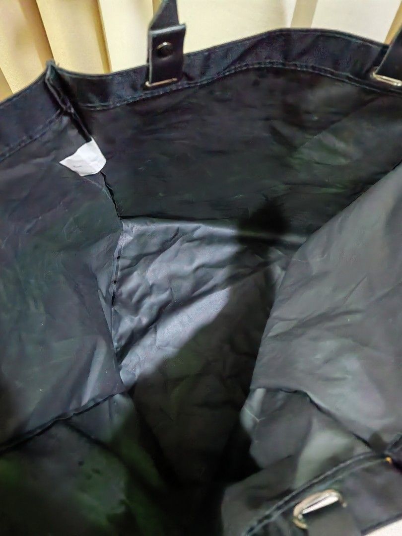 Black Nylon Tote Bag (Category: Tote Bags) located in Makati City. Submitted by prelovedtreatedwithlove (Listing ID 1468888637, Image 3). Description: - Color: Solid black - Material: Lightweight, durable, and fold-friendly nylon - Capacity: Spacious square shape - Condition:Excellent A-172.