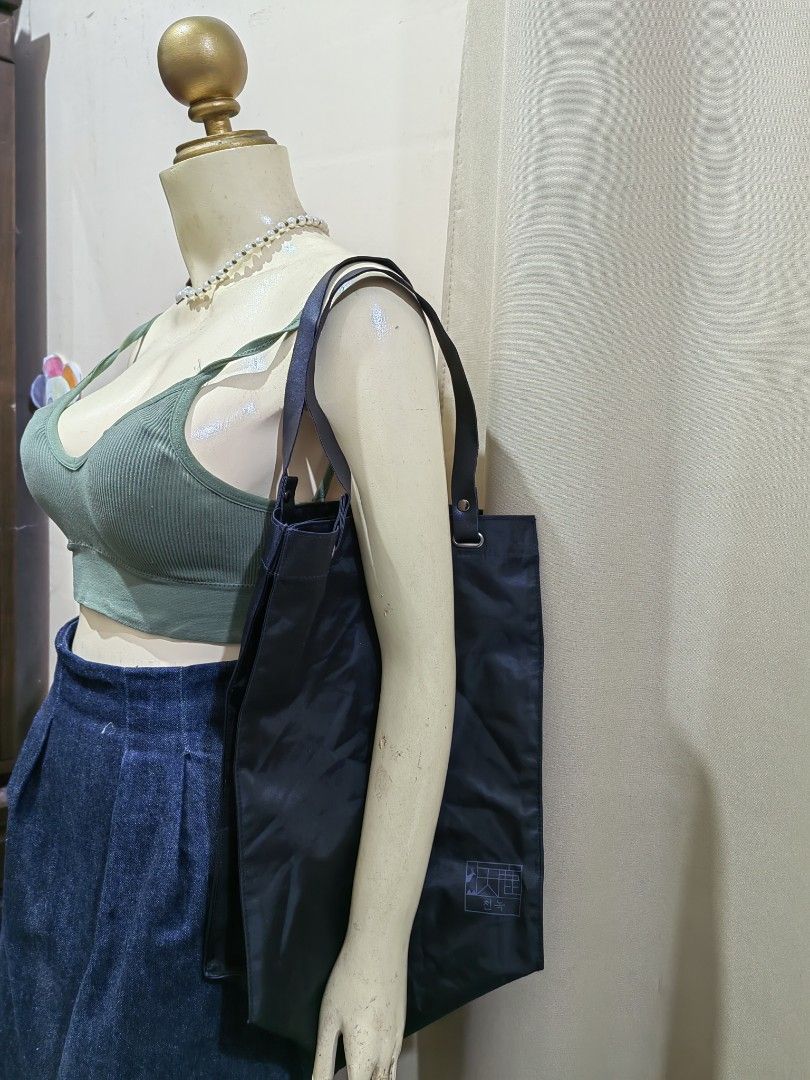 Black Nylon Tote Bag (Category: Tote Bags) located in Makati City. Submitted by prelovedtreatedwithlove (Listing ID 1468888637, Image 1). Description: - Color: Solid black - Material: Lightweight, durable, and fold-friendly nylon - Capacity: Spacious square shape - Condition:Excellent A-172.