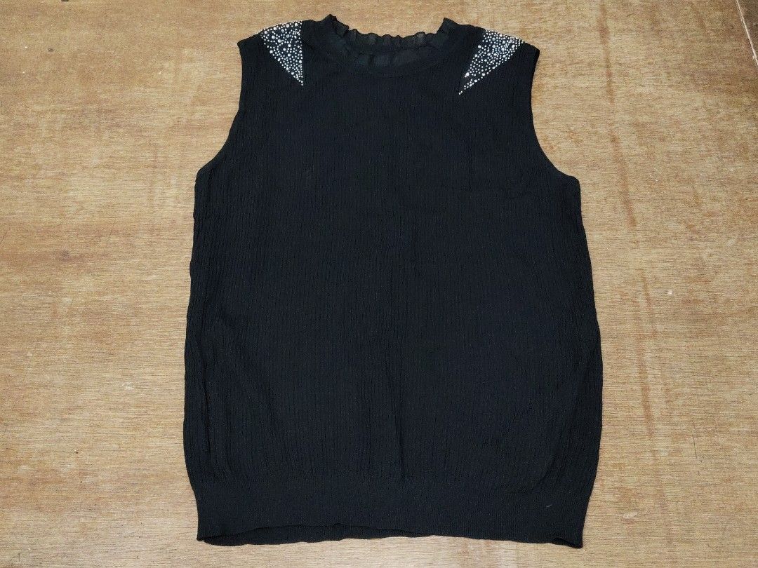 Black sleeveless top with rhinestone shoulders (Category: Sleeveless) located in San Juan City. Submitted by rhennx (Listing ID 1468905313, Image 1). Description: - Color: Black - Style: Sleeveless knit top with pull-on design - Details: Eye-catching rhinestones on both shoulders with a delicate ruffled round neckline - Fit: Straight hem at the waist, thick fabric - Versatility: Perfect for pairing with your favorite jeans or skirts for an effort