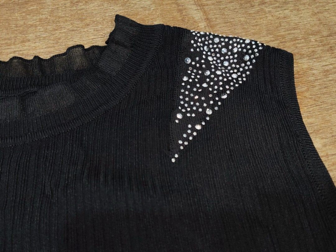 Black sleeveless top with rhinestone shoulders (Category: Sleeveless) located in San Juan City. Submitted by rhennx (Listing ID 1468905313, Image 2). Description: - Color: Black - Style: Sleeveless knit top with pull-on design - Details: Eye-catching rhinestones on both shoulders with a delicate ruffled round neckline - Fit: Straight hem at the waist, thick fabric - Versatility: Perfect for pairing with your favorite jeans or skirts for an effort