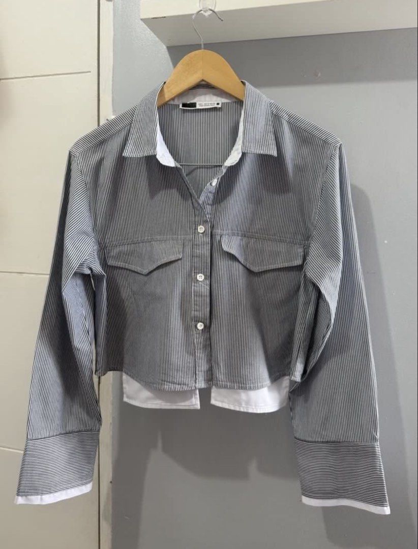 Black Striped Layered Crop Shirt (Category: Shirts) located in Batangas. Submitted by melocollects (Listing ID 1468807217, Image 3). Description: - Size: EUR L, USA 10, MEX 32 - Color: Black and white vertical stripes - Style: Cropped button-down shirt with layered white undershirt hem and cuffs - Details: Pointed collar, dual chest flap pockets, front button closure - Origin: Made in Bangladesh.