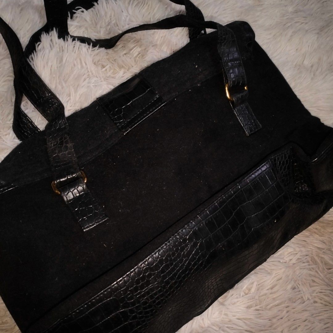 Black Tote Bag with Crocodile Embossed Trim and Studs (Category: Tote Bags) located in Manila. Submitted by littlenicsfinds (Listing ID 1468741255, Image 2). Description: - Style: Black fabric tote with glossy croc-embossed faux leather panels - Hardware: Gold-tone studs and buckle accents on straps - Design: Structured bottom base with matching croc pattern - Capacity: Spacious interior for daily essentials - Versatility: Perfect size for school