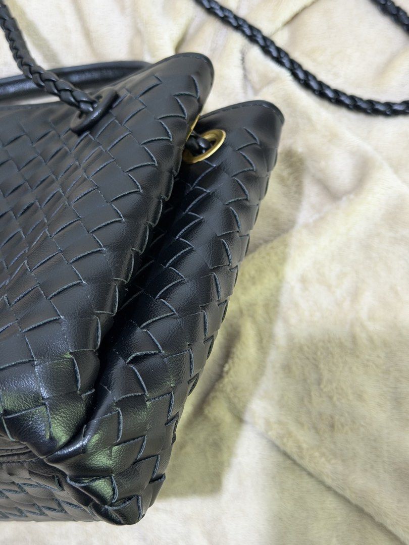 Black woven leather handbag with gold hardware (Category: Luxury Bags & Wallets) located in Manila. Submitted by declutterwtmaan (Listing ID 1468749486, Image 3). Description: - Material: Premium black woven leather with zero scuffs - Hardware: Elegant gold-tone front closure - Straps: Convenient top handles and a stylish braided crossbody strap - Interior: Dark fabric lining equipped with a secure zip pocket - Condition: Clean, well-maintained, 