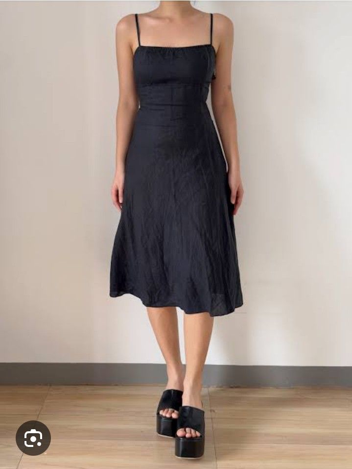 Blacl strechable dress (Category: Dresses) located in Manila. Submitted by wheneity67thifted (Listing ID 1468927270, Image 1). Description: The image shows a classic black spaghetti-strap midi or knee-length fit-and-flare dress with a sweetheart or scoop neckline and a paneled/flared skirt.