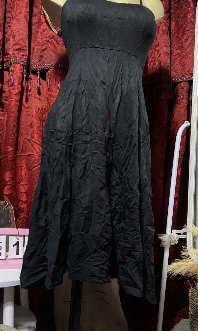 Blacl strechable dress (Category: Dresses) located in Manila. Submitted by wheneity67thifted (Listing ID 1468927270, Image 3). Description: The image shows a classic black spaghetti-strap midi or knee-length fit-and-flare dress with a sweetheart or scoop neckline and a paneled/flared skirt.