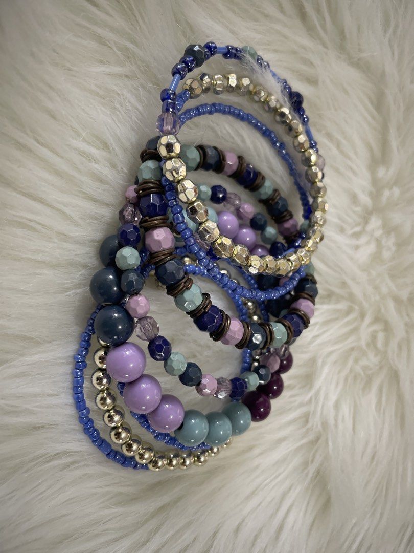 Blue and Purple Beaded Stackable Bracelets Set (Category: Bracelets) located in San Juan City. Submitted by redrosierose (Listing ID 1468714272, Image 1). Description: - Set of stackable bracelets in blue, purple, light teal, and metallic gold - Mix of seed beads, smooth round beads, and faceted beads - Crafted on a durable stretch cord that easily fits most wrists - Wear them all together for a chunky stack or mix and match separately - Adds a f