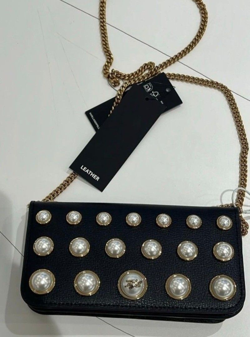 BNWT Karl Lagerfeld Paris Kosette Mini Shoulder Bag (Category: Cross-body Bags) located in Manila. Submitted by eveeven (Listing ID 1468778407, Image 2). Description: - Brand: Karl Lagerfeld Paris - Style: Kosette mini shoulder bag - Color: Black with gold-tone hardware - Material: Premium leather - Strap: Gold-tone chain strap - Closure: Magnetic snap closure - Interior: Lined with a convenient zip pocket - Details: Pearl-studded front flap with