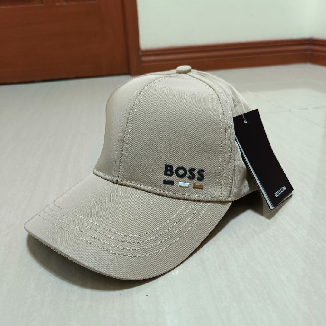 BOSS Hugo Boss Cap Rubberized Logo Adjustable Back (Category: Caps & Hats) located in Nasugbu. Submitted by staffpicks1515 (Listing ID 1468795047, Image 2). Description: - 100% Authentic Hugo Boss beige cap - Brand new with original hangtags attached - Raised rubberized BOSS logo with contrast stripes on the front - Adjustable strap with metal buckle for a custom fit - Premium interior lining with all-over BOSS monogram pattern - Perfect for dail