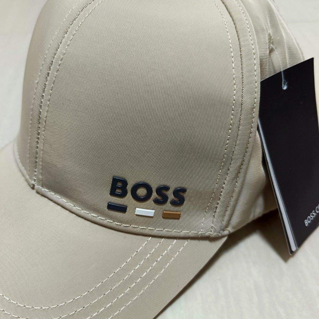 BOSS Hugo Boss Cap Rubberized Logo Adjustable Back (Category: Caps & Hats) located in Nasugbu. Submitted by staffpicks1515 (Listing ID 1468795047, Image 3). Description: - 100% Authentic Hugo Boss beige cap - Brand new with original hangtags attached - Raised rubberized BOSS logo with contrast stripes on the front - Adjustable strap with metal buckle for a custom fit - Premium interior lining with all-over BOSS monogram pattern - Perfect for dail