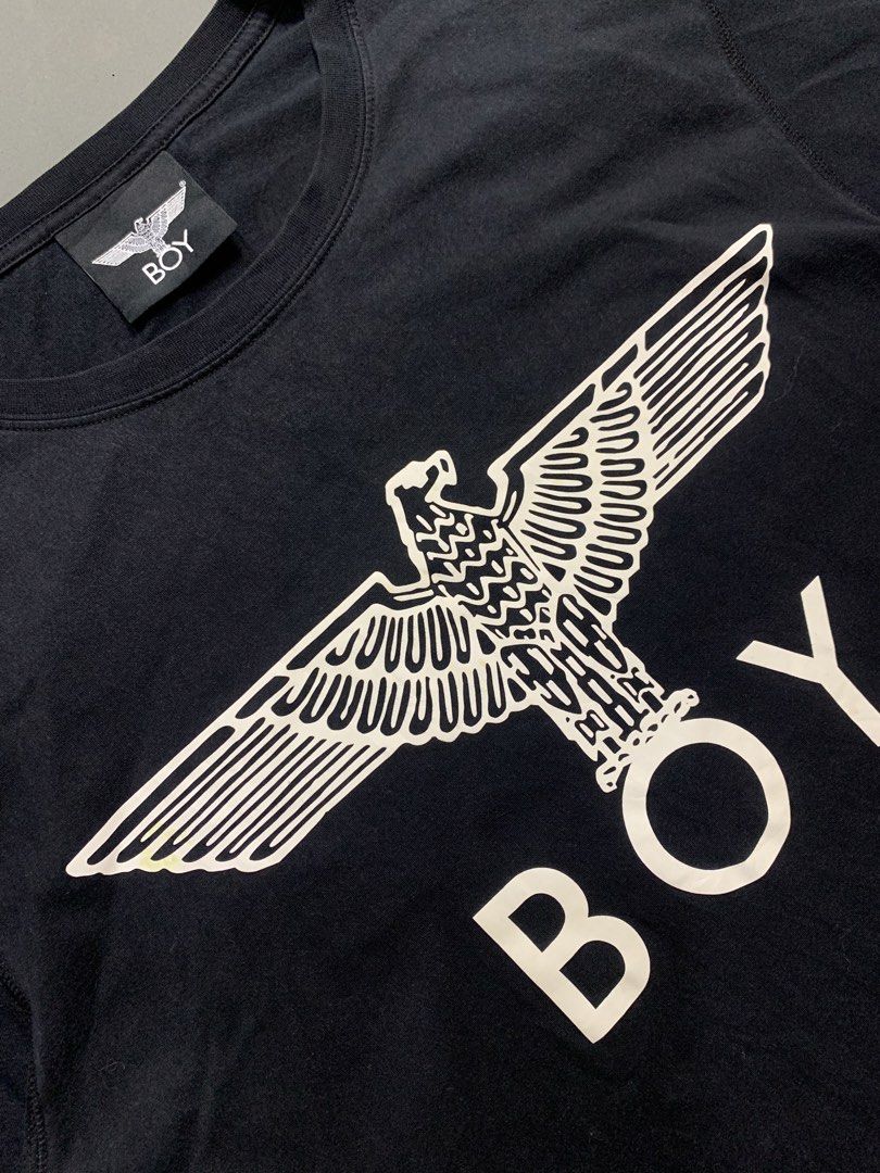 BOY London Black Eagle Logo T-Shirt (Category: Tshirts & Polo Shirts ) located in Kalibo. Submitted by gneiss2002 (Listing ID 1468846690, Image 3). Description: - Brand: BOY London - Color: Classic Black - Design: Iconic white eagle graphic with block lettering on chest and back design BOY - Material: Soft, premium cotton for daily comfort - Fit: Standard crew neckline and short sleeves - Condition: Excellent / Well-maintained - Style: Casual str