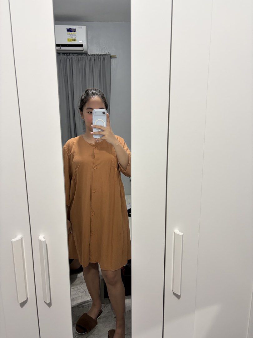 Brown button-down midi dress (Category: Dresses) located in Bulacan. Submitted by lenggayy (Listing ID 1468801621, Image 1). Description: - Color: Brown - Length: Knee-length - Design: Round neckline with full front button-down closure and short sleeves - Fit: Loose, clean, and neat - Fabric: Soft and comfortable material, easy to throw on for casual days.