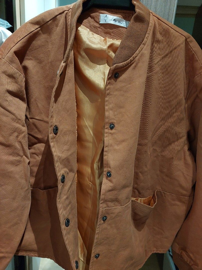 Brown Button-Up Jacket (Category: Coats, Jackets and Outerwear) located in Singapore. Submitted by jasminelch (Listing ID 1468791925, Image 4). Description: - Brand new without tag - Brown button-up jacket with structured panelling - Comfortable ribbed collar and long sleeves with ribbed cuffs - Smooth inner lining in a contrasting warm tone - Clean fabric finish throughout - Versatile casual outer layer, easy to match with various outfits - Cond