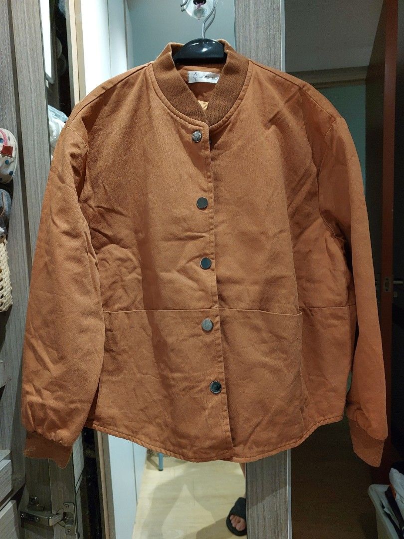 Brown Button-Up Jacket (Category: Coats, Jackets and Outerwear) located in Singapore. Submitted by jasminelch (Listing ID 1468791925, Image 2). Description: - Brand new without tag - Brown button-up jacket with structured panelling - Comfortable ribbed collar and long sleeves with ribbed cuffs - Smooth inner lining in a contrasting warm tone - Clean fabric finish throughout - Versatile casual outer layer, easy to match with various outfits - Cond