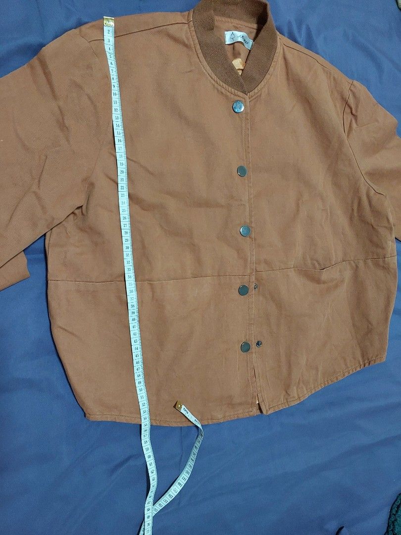 Brown Button-Up Jacket (Category: Coats, Jackets and Outerwear) located in Singapore. Submitted by jasminelch (Listing ID 1468791925, Image 5). Description: - Brand new without tag - Brown button-up jacket with structured panelling - Comfortable ribbed collar and long sleeves with ribbed cuffs - Smooth inner lining in a contrasting warm tone - Clean fabric finish throughout - Versatile casual outer layer, easy to match with various outfits - Cond
