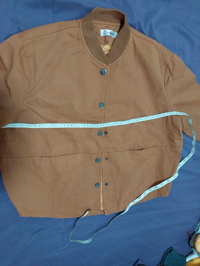 Brown Button-Up Jacket (Category: Coats, Jackets and Outerwear) located in Singapore. Submitted by jasminelch (Listing ID 1468791925, Image 6). Description: - Brand new without tag - Brown button-up jacket with structured panelling - Comfortable ribbed collar and long sleeves with ribbed cuffs - Smooth inner lining in a contrasting warm tone - Clean fabric finish throughout - Versatile casual outer layer, easy to match with various outfits - Cond