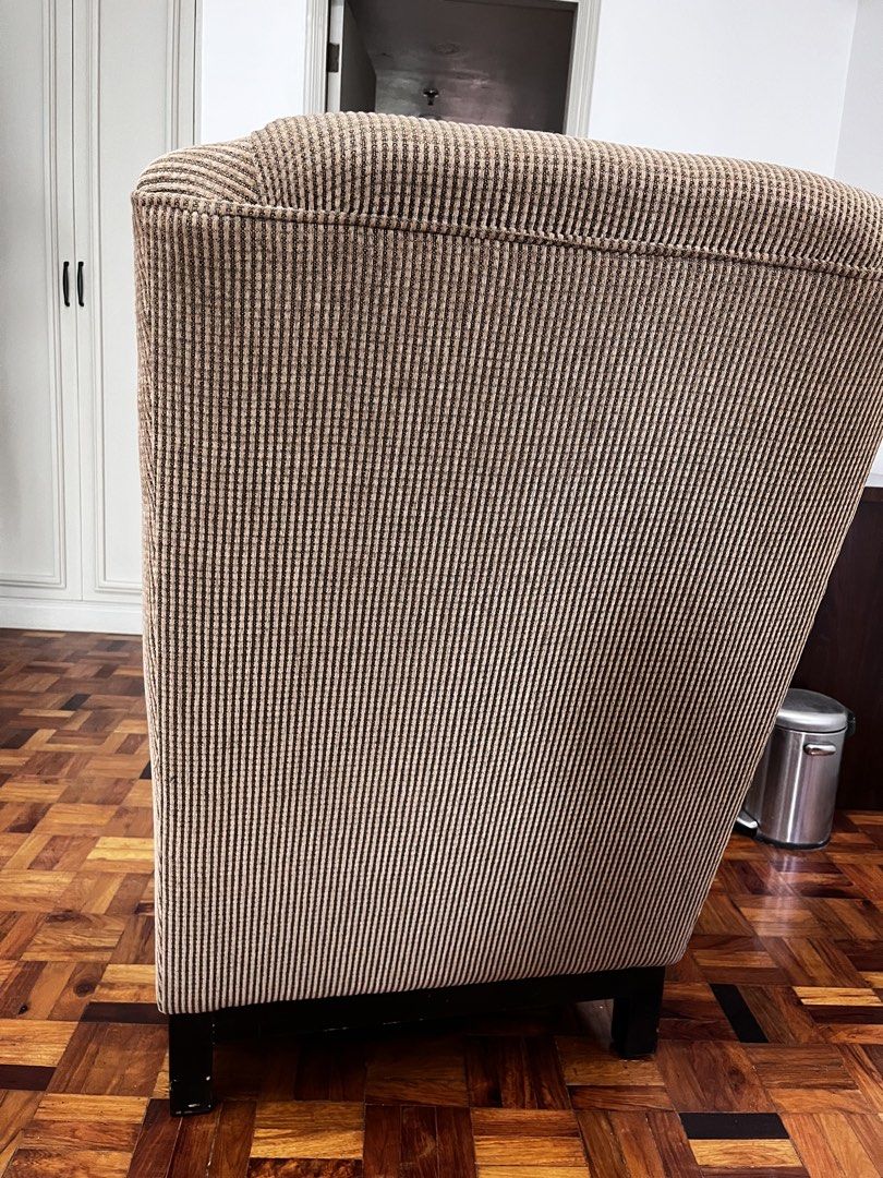 Brown Corduroy Wingback Armchair (Category: Chairs) located in Makati City. Submitted by andoypakoykoy (Listing ID 1468921174, Image 3). Description: - Brown corduroy upholstery with clean vertical ribbing - High backrest and wide armrests for ultimate comfort - Sturdy solid construction with dark wood block feet - Versatile neutral earth tone, ideal for living rooms, reading corners, or studies.