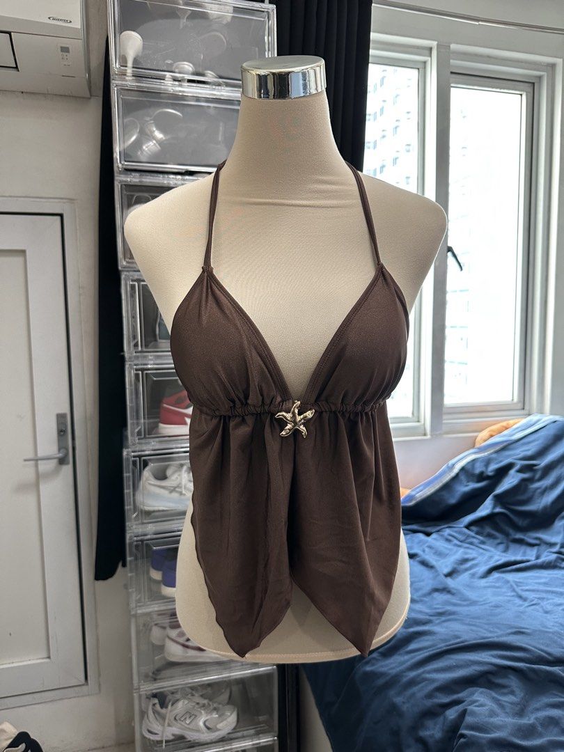 Brown Halter Top with Starfish Accent (Category: Sleeveless) located in Quezon City. Submitted by valeriorac74670 (Listing ID 1468817061, Image 1). Description: - Color: Brown - Design: Halter top with a plunging neckline and gathered bodice - Center Detail: Cute gold starfish charm at the front - Hemline: Trendy asymmetric pointy hem - Closure: Adjustable tie-neck straps at the back - Condition: Brand new/Mint (ready to wear!).