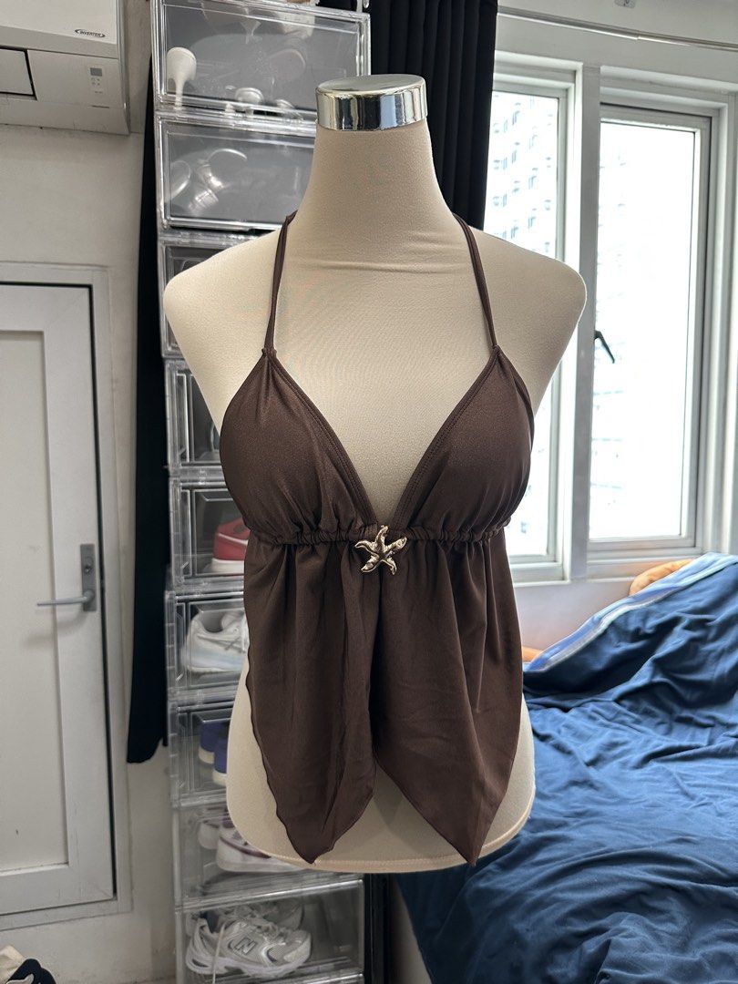 Brown Halter Top with Starfish Accent (Category: Sleeveless) located in Quezon City. Submitted by valeriorac74670 (Listing ID 1468817061, Image 2). Description: - Color: Brown - Design: Halter top with a plunging neckline and gathered bodice - Center Detail: Cute gold starfish charm at the front - Hemline: Trendy asymmetric pointy hem - Closure: Adjustable tie-neck straps at the back - Condition: Brand new/Mint (ready to wear!).