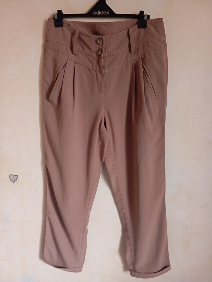 Brown high-waisted cropped trousers with cuffed hem (Category: Jeans) located in Cabanatuan. Submitted by w3ng.gay (Listing ID 1468763373, Image 1). Description: - Color: Versatile neutral brown - Fit: High-waisted with a stylish pleated front - Details: Double-button waistband, slanted pockets, and rolled cuffs - Back: Two welt pockets with button detail - Material: Smooth and lightweight fabric - Condition:loose stitching but can ne sewn bur st